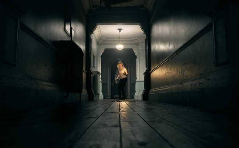 Resident Evil Requiem Grace Walking Towards Camera At The End Of A Long Dark Hall.